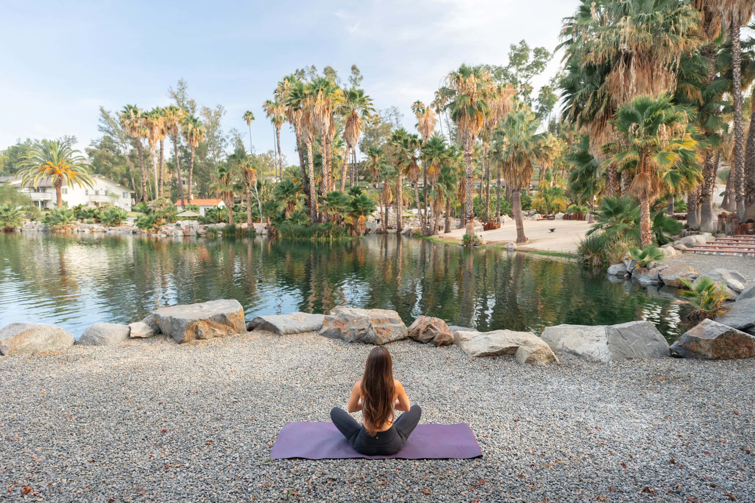 guest doing yoga by water