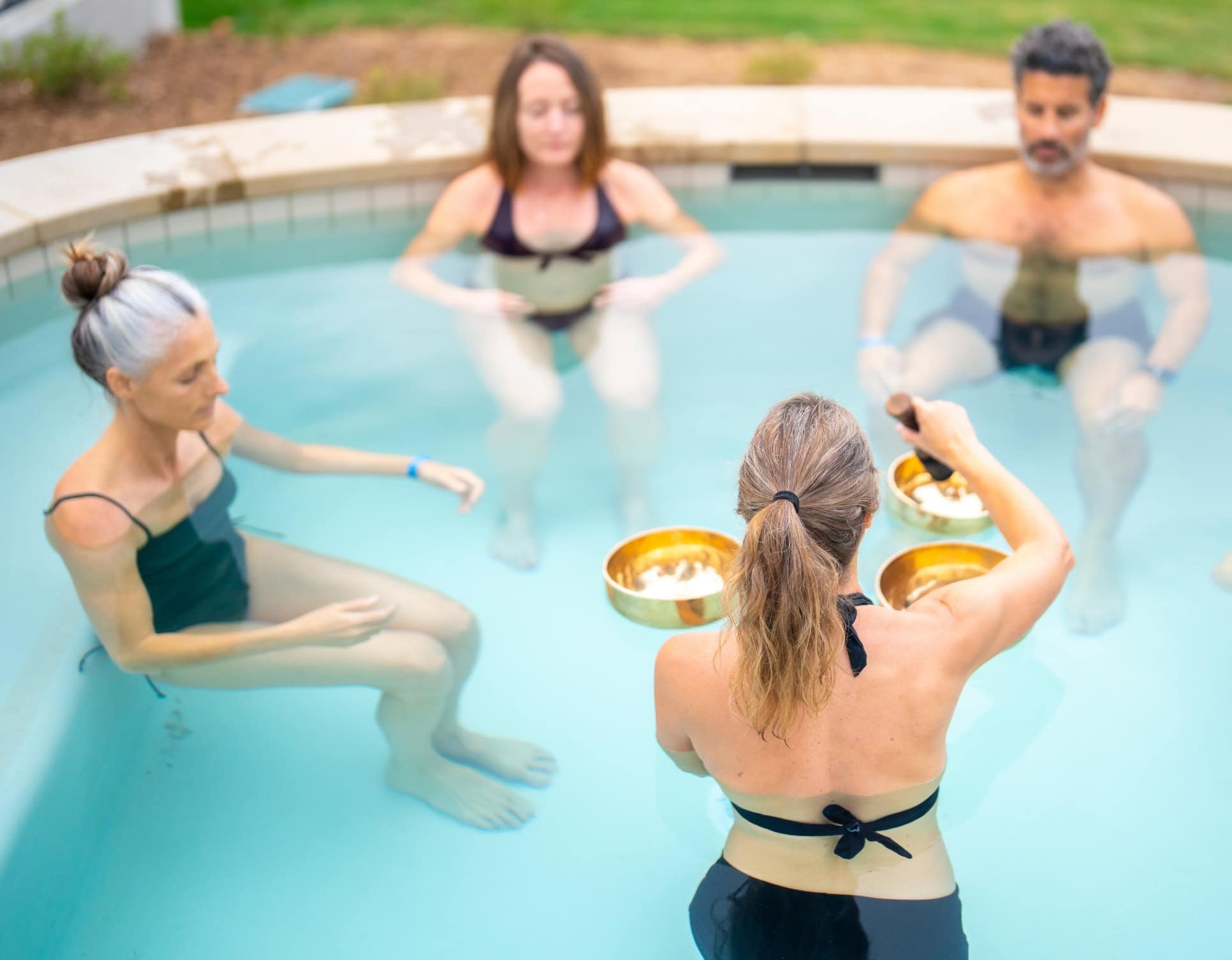 guests meditating in pool