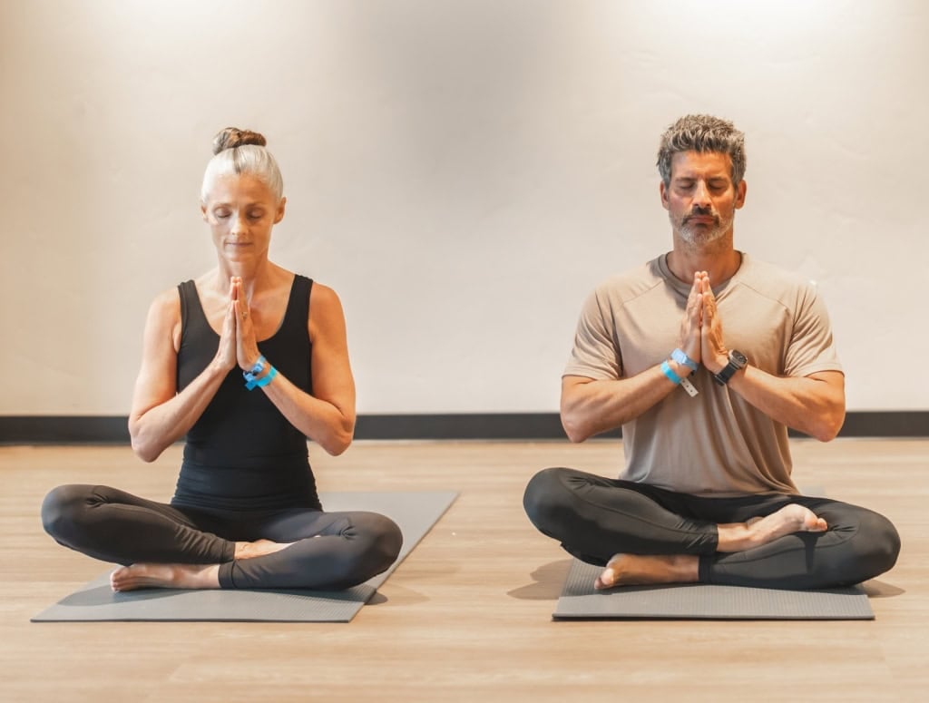 Three guests doing yoga.