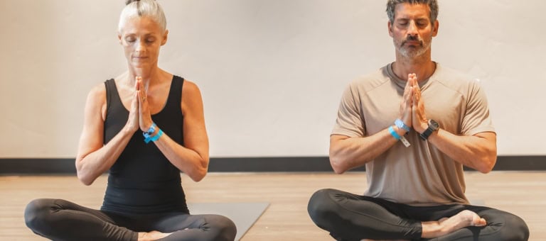 Three guests doing yoga.