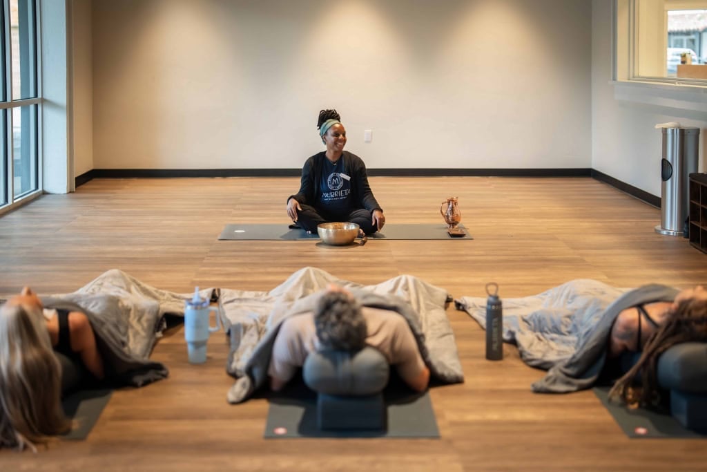 Group of people practicing yoga in a wellness center at Murrieta Hot Springs Resort.