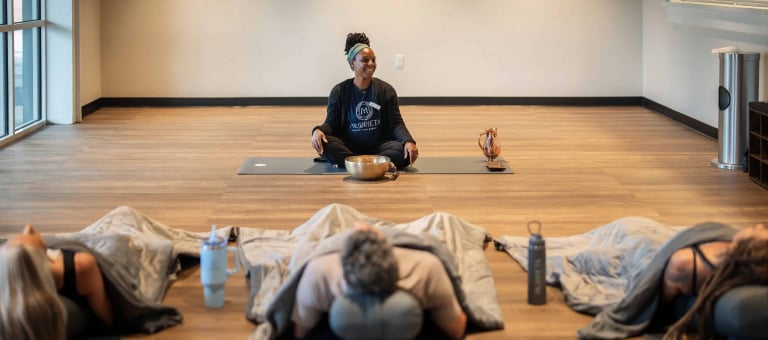 Group of people practicing yoga in a wellness center at Murrieta Hot Springs Resort.