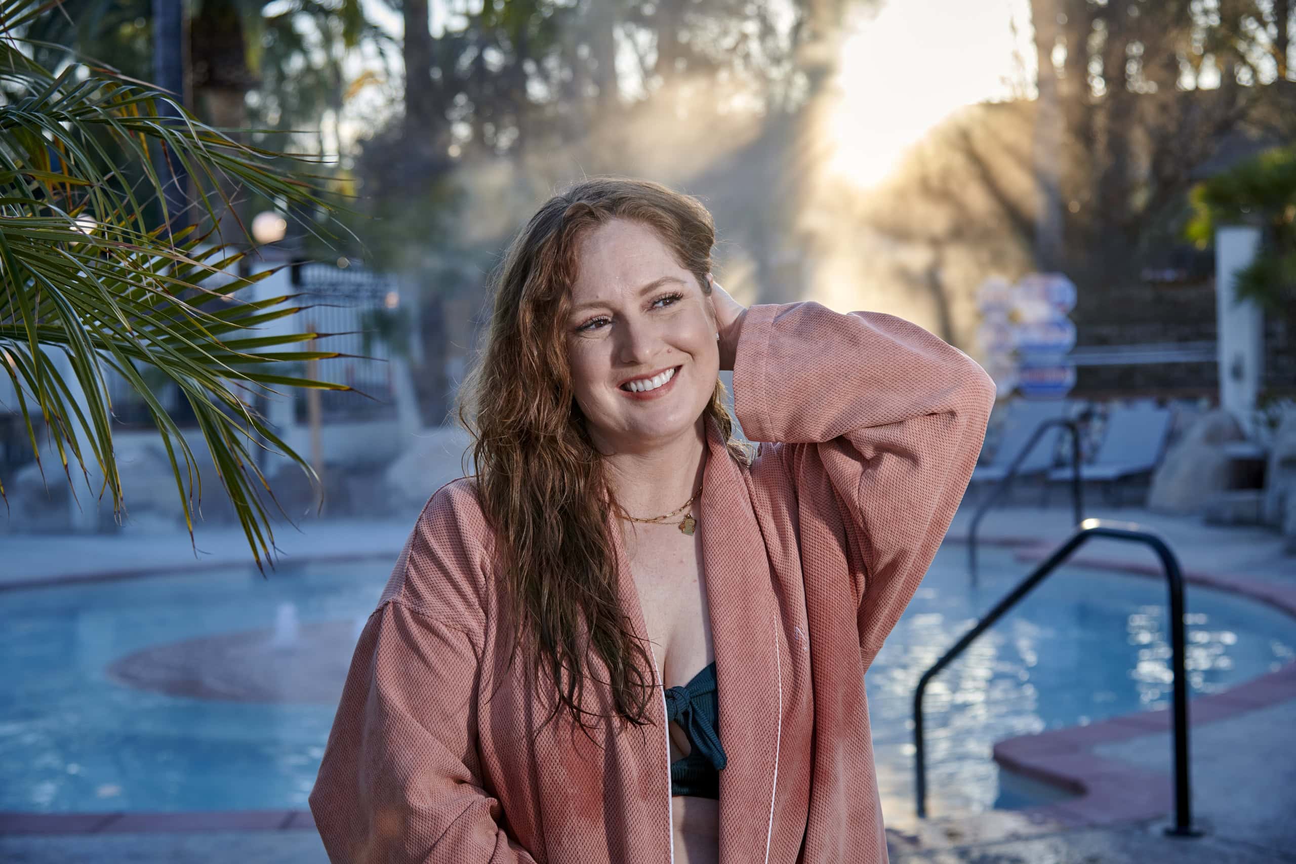 Woman enjoying a relaxing moment at Murrieta Hot Springs Resort outdoor pool.