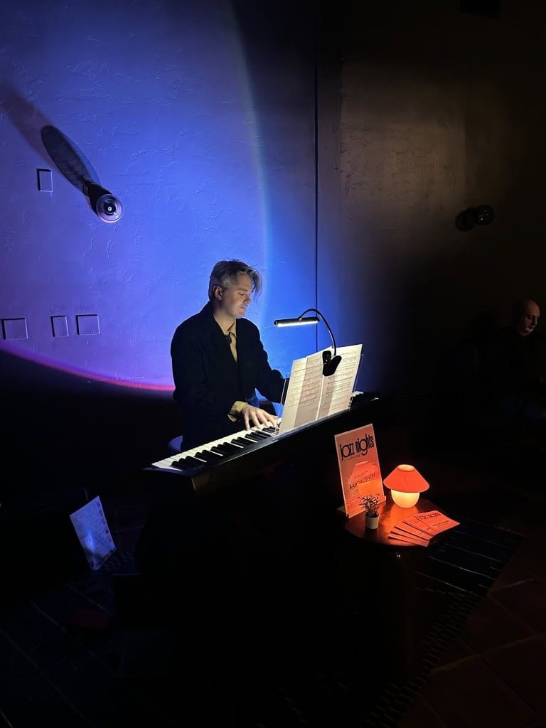 Live musician playing keyboard at Murrieta Hot Springs Resort with ambient lighting.