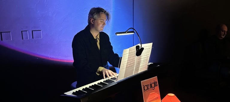 Live musician playing keyboard at Murrieta Hot Springs Resort with ambient lighting.