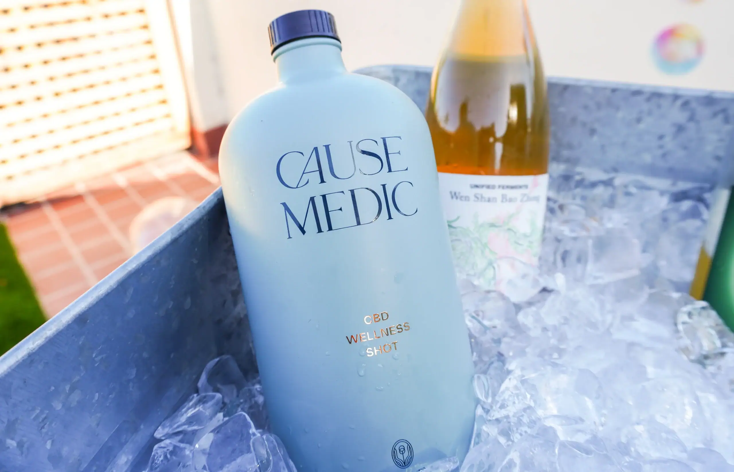 CauseMedic CBD Wellness Shot in ice-filled cooler for relaxation and health.