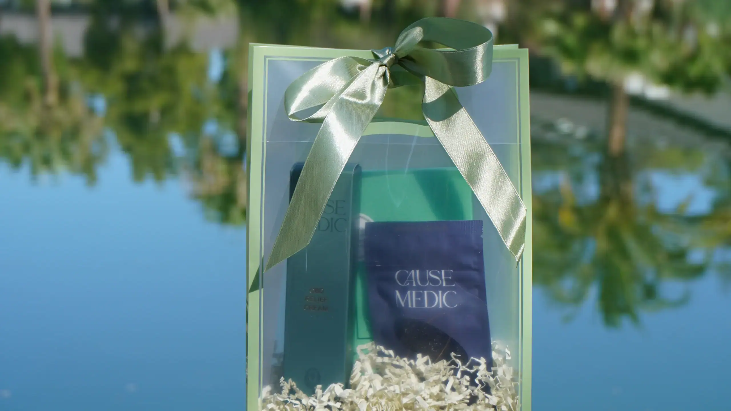 Wellness gift set with CauseMedic products and a green ribbon.
