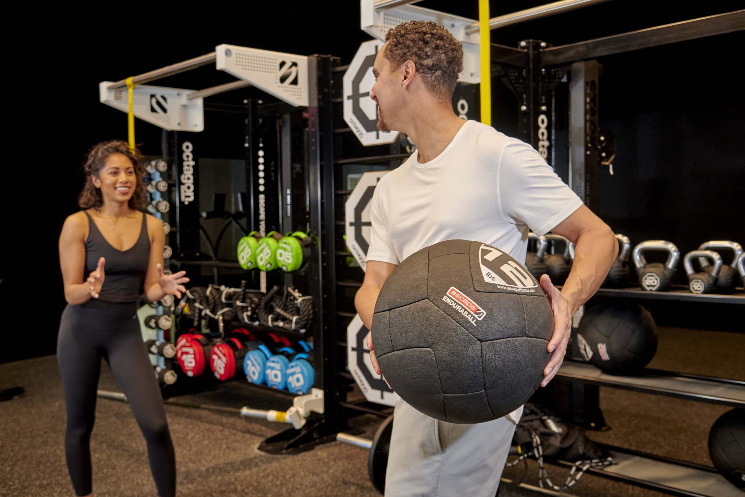 People exercising in a fitness center with weights and equipment at Murrieta Hot Springs.