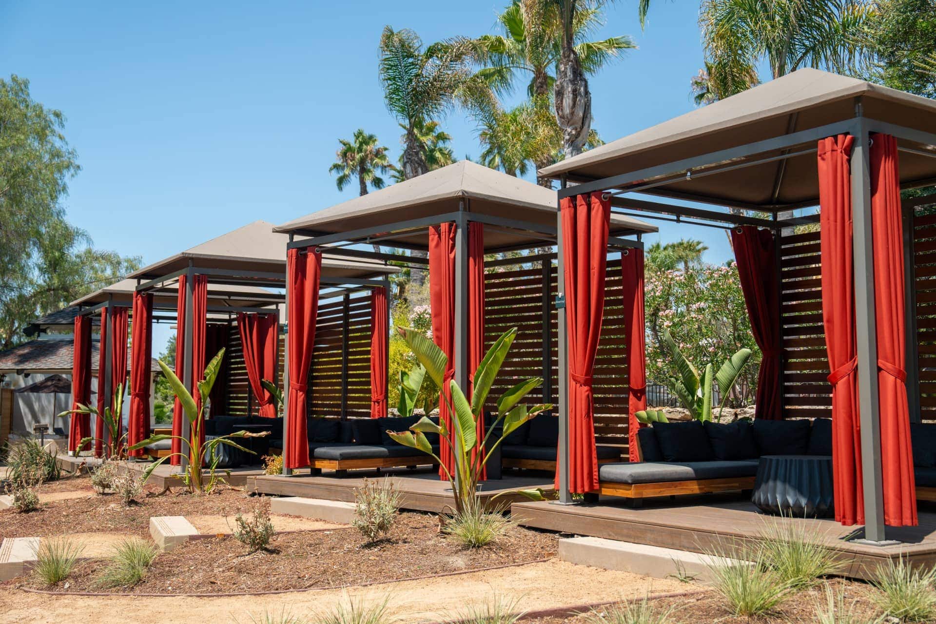 Luxury cabanas with curtains at Murrieta Hot Springs Resort for relaxation.